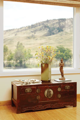 The master bedroom window provides stunning views of the foothills; beneath it a chest from eighteenth-century northern China.